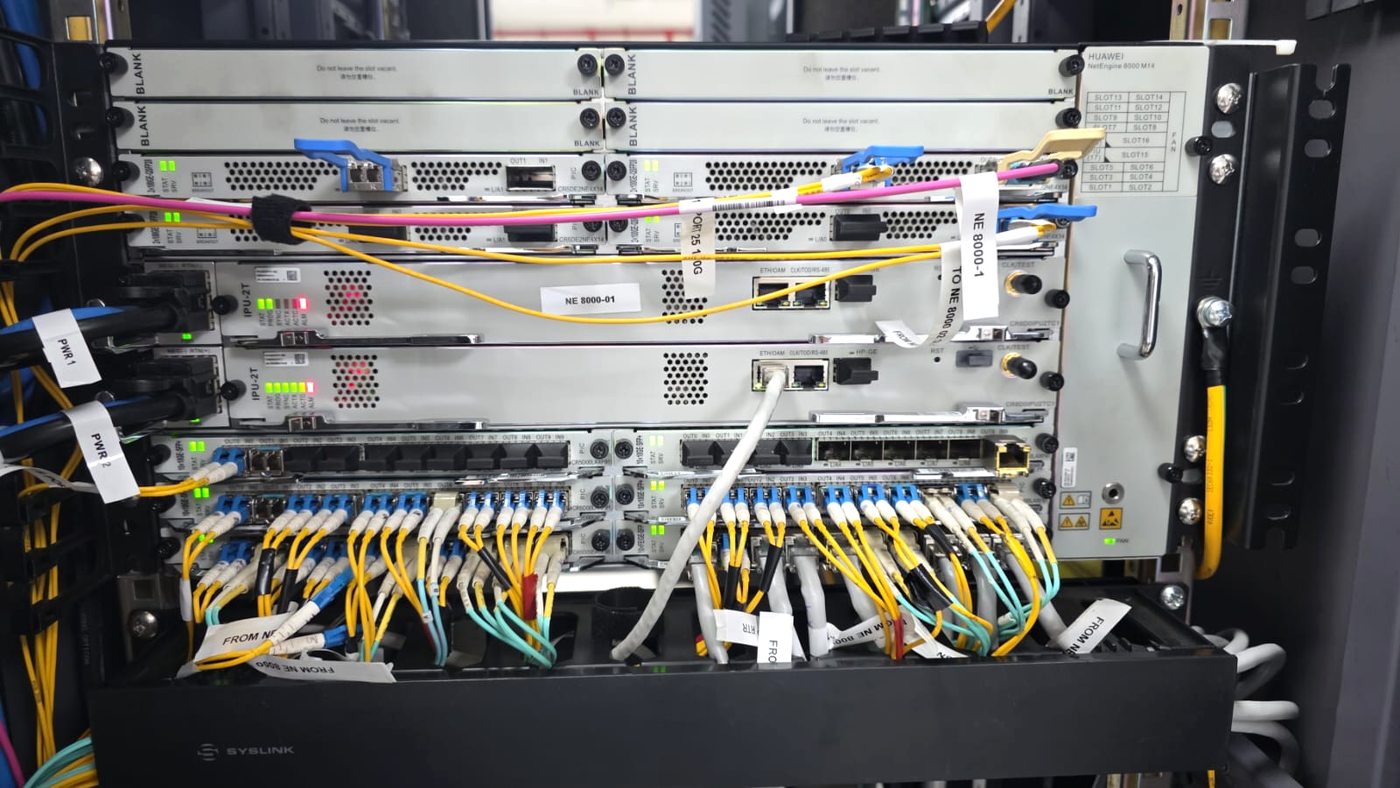 Carrier-grade Huawei NetEngine 8000 chassis router with labelled fibre patch leads across line cards